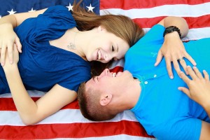 Couple laying on USA flag planning for VA Loans